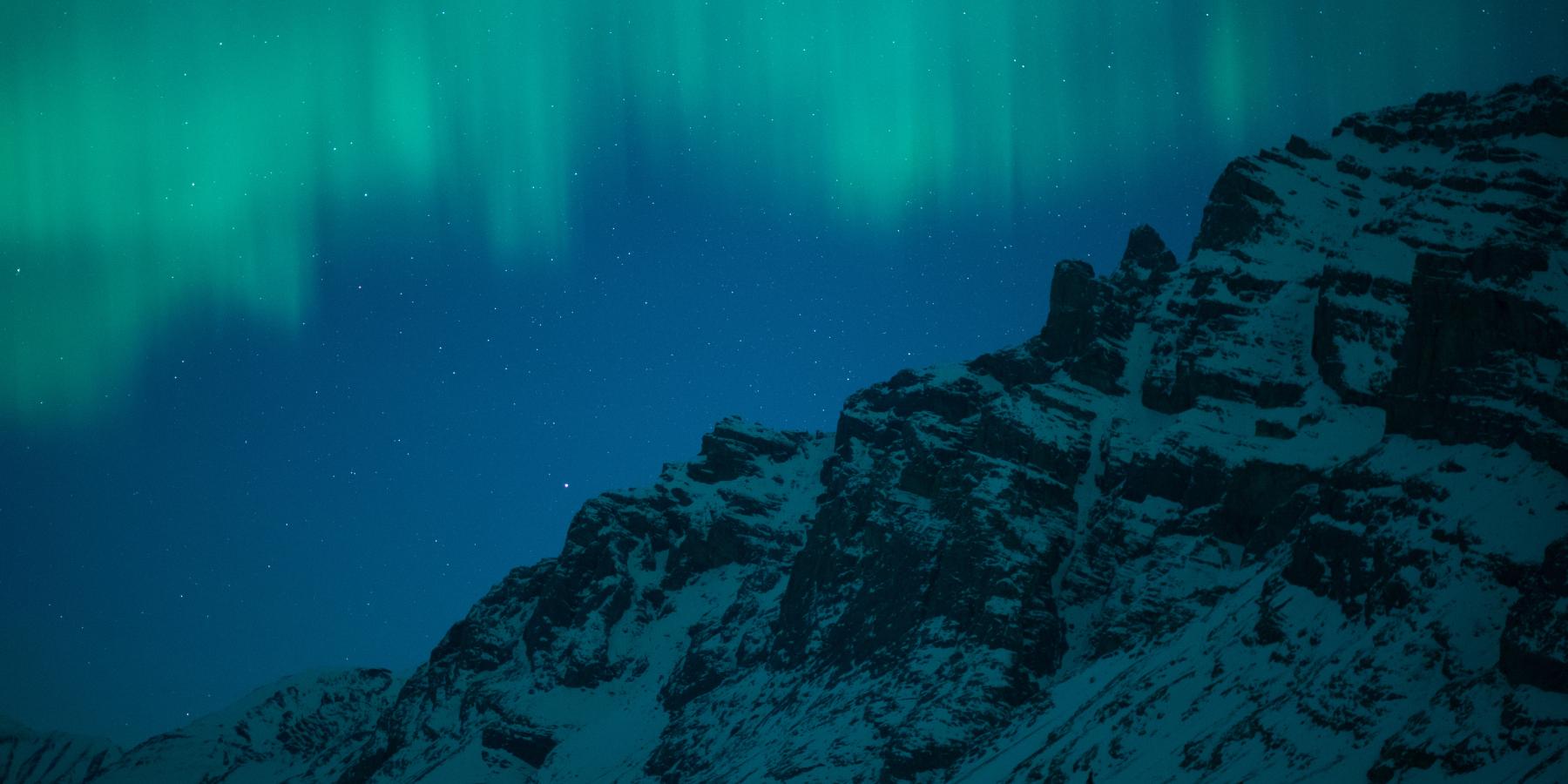 aurora over icy mountain