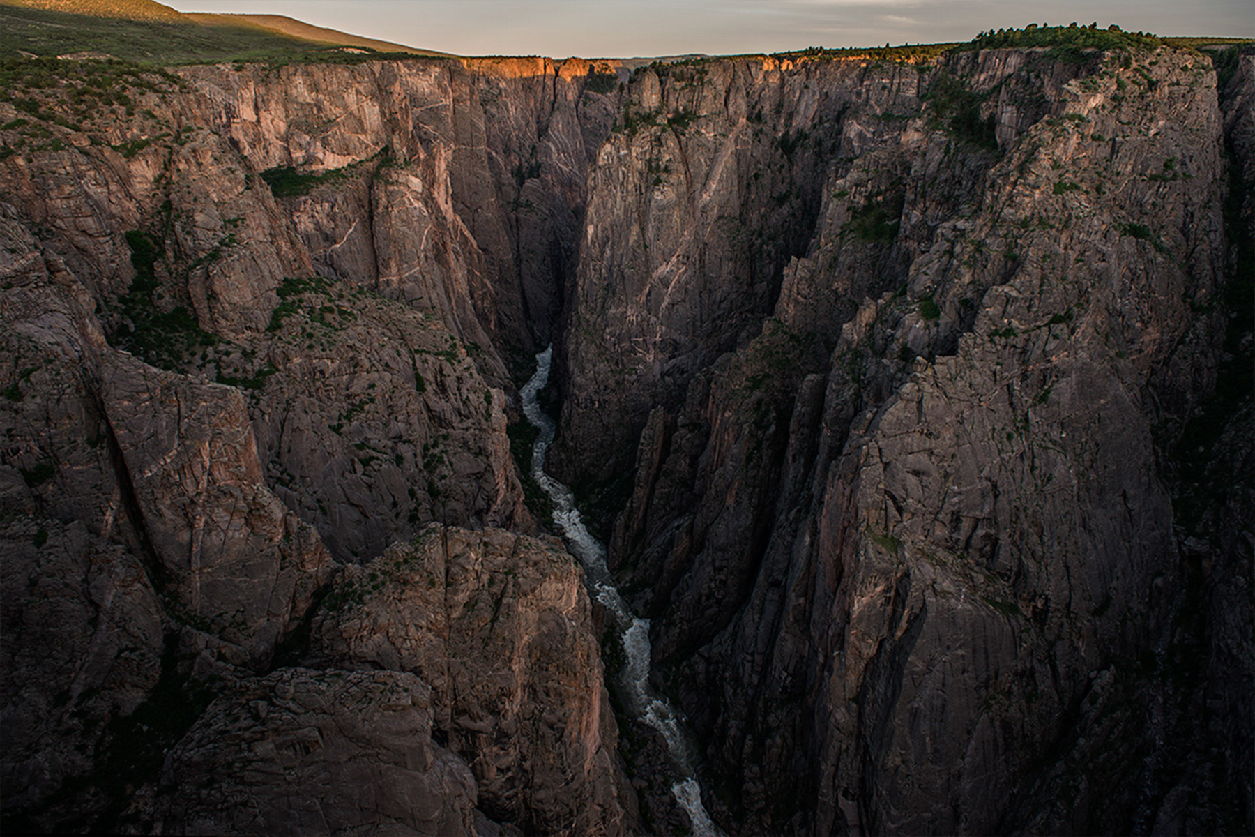 tall canyon with river flowing down below
