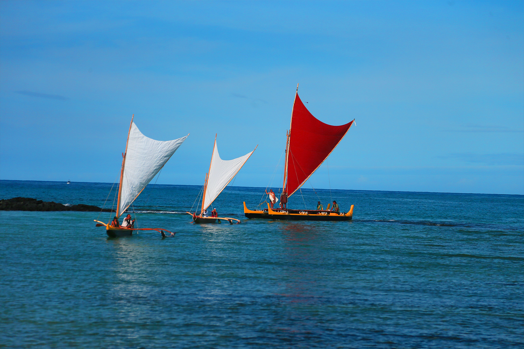 native hawaiian boats on the water