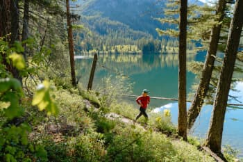Solo jogger along an alpine lake. Copyright The Wilderness Society