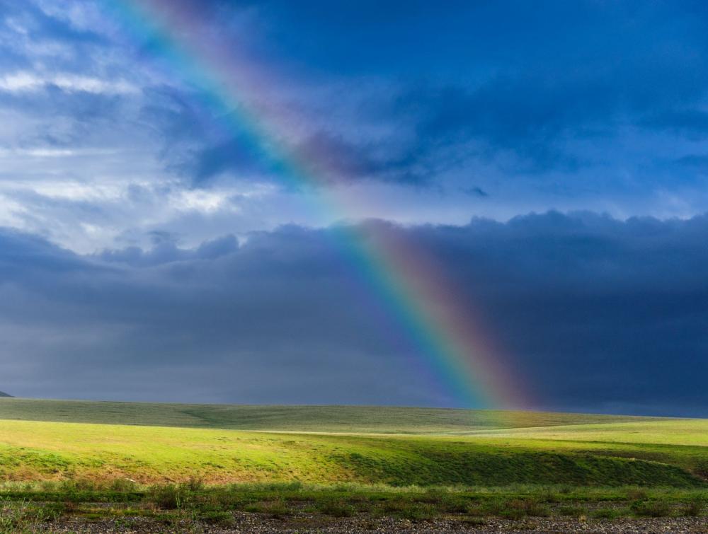 Rainbow across the blue sky in the Arctic National Wildlife Refuge.