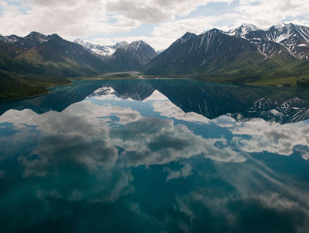 Reflection of mountains in water in Lake Clark National Park, AK.