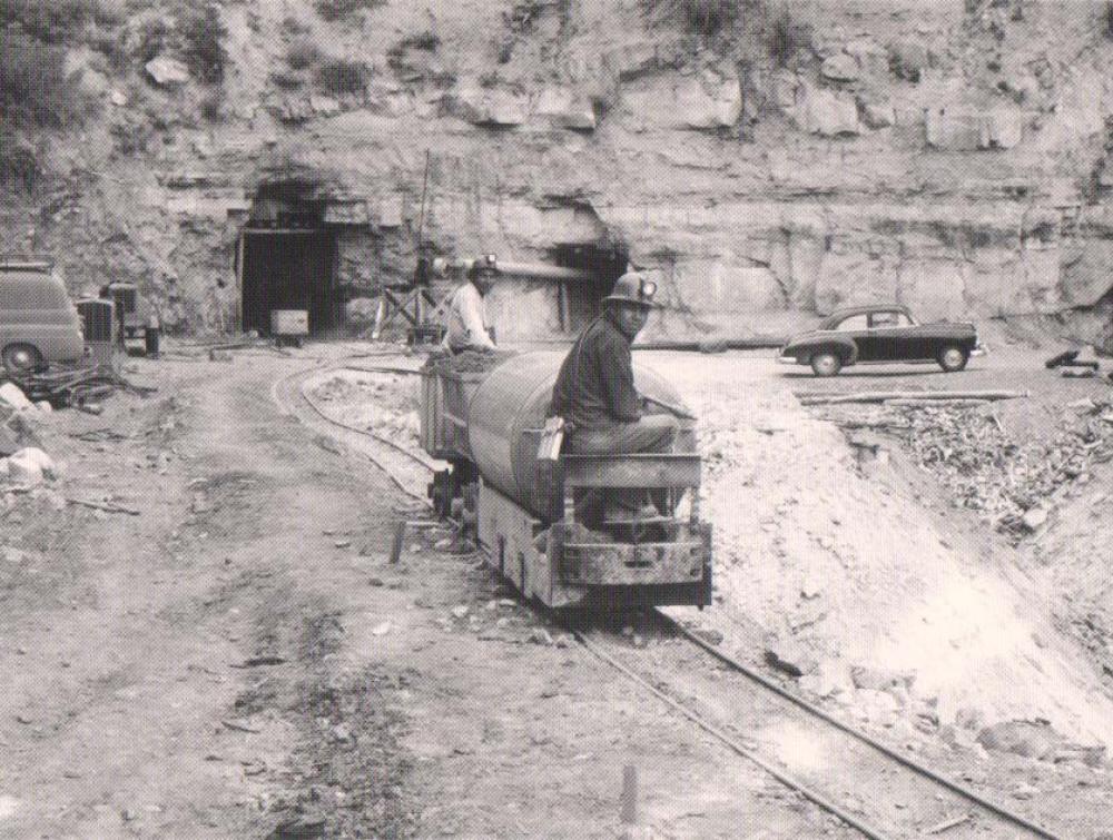 Navajo miners exit a mine in Cove, Arizona, on top of a small train.