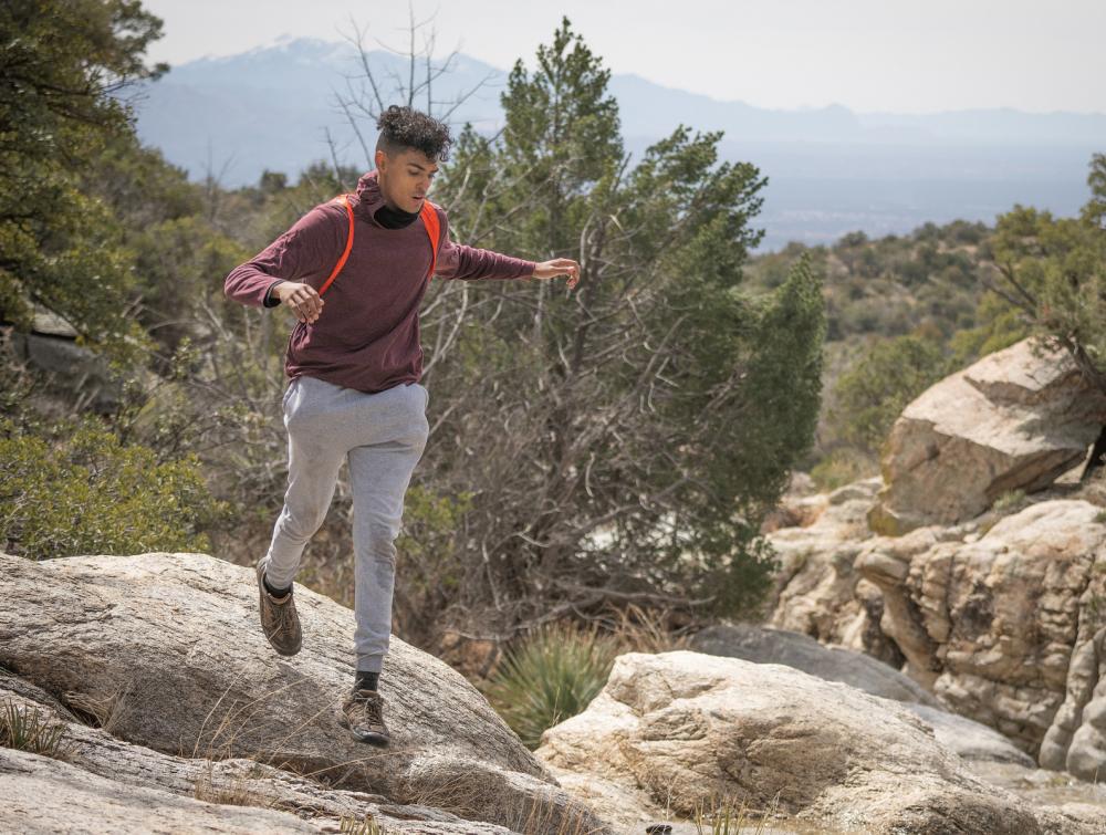 Young hiker on rocks in Saguaro National Park Park, Arizona