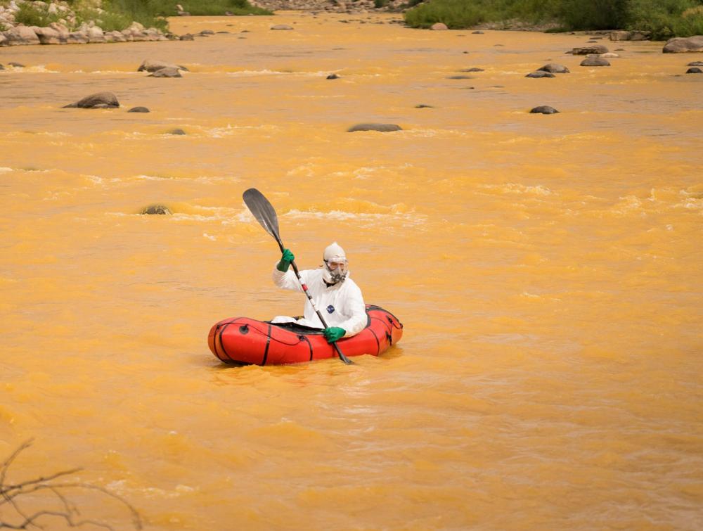 Kayaker in the Animas River after the Gold King Mine accident in Colorado.