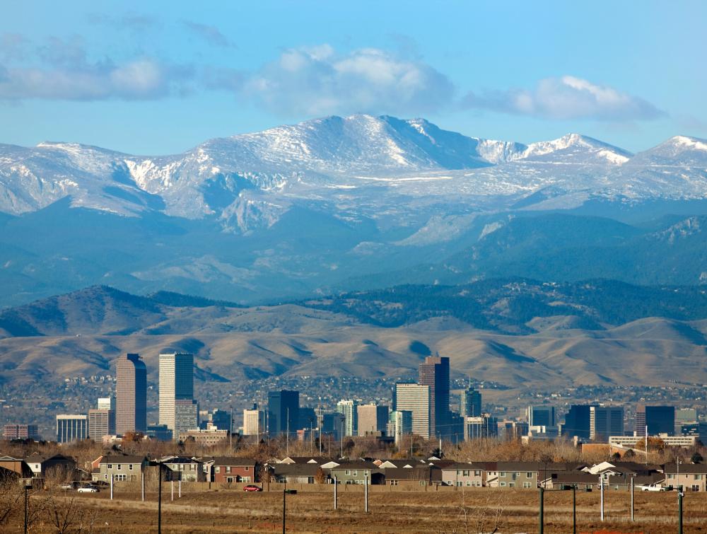 Rocky Mountains Front Range homes and downtown Denver Colorado skyscrapers