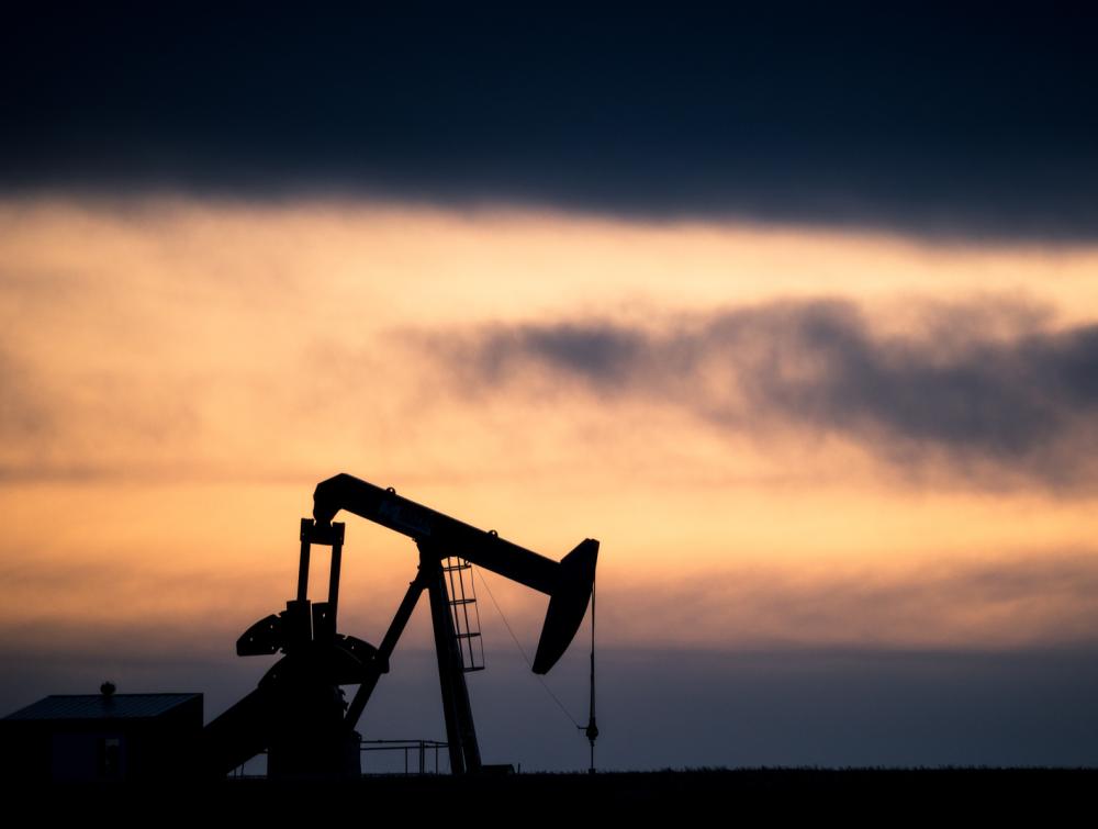 Oil rig with colorful sunset.