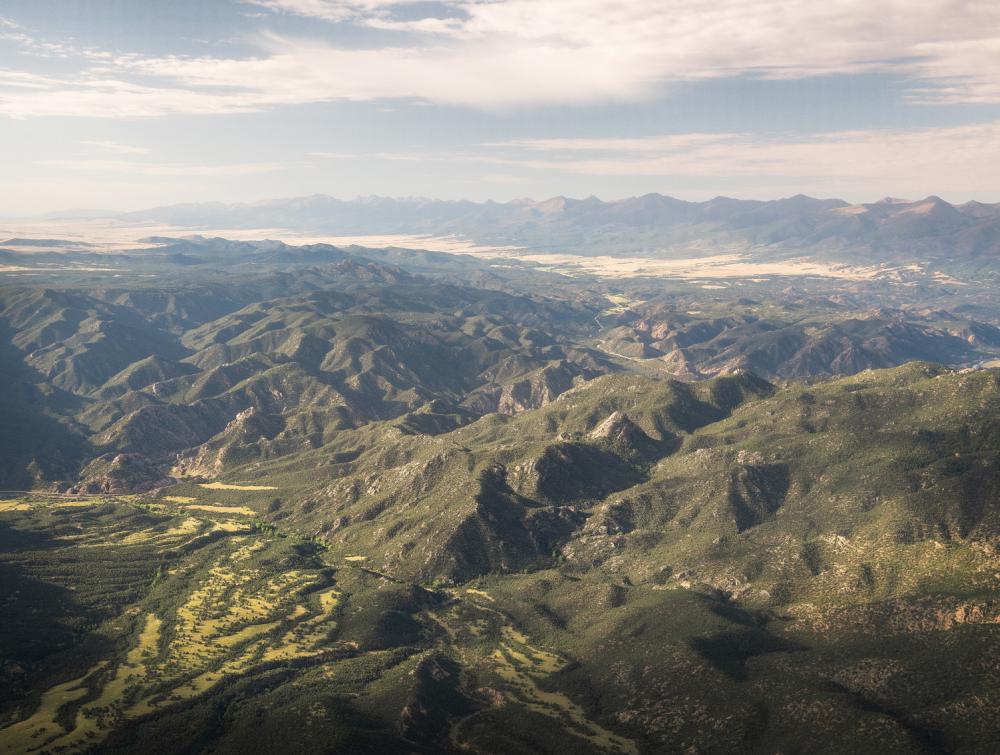 Aerial view of mountainous landscape dotted with trees