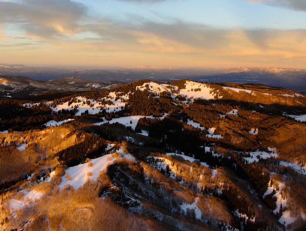 aerial photo of mountains with some snow left