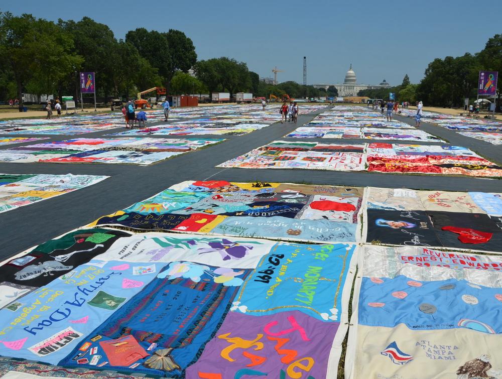 the AIDS quilt stretches out on the National Mall, with the Capitol in the back