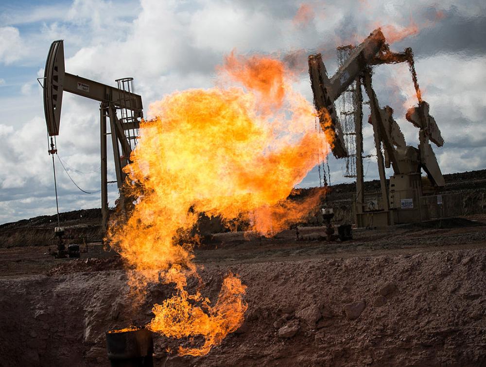 A gas flare is seen at an oil well site on July 26, 2013 outside Williston, North Dakota