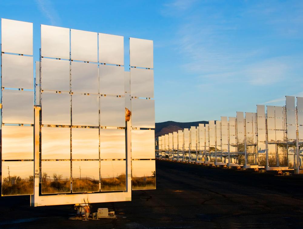 solar panels reflecting sunset in desert