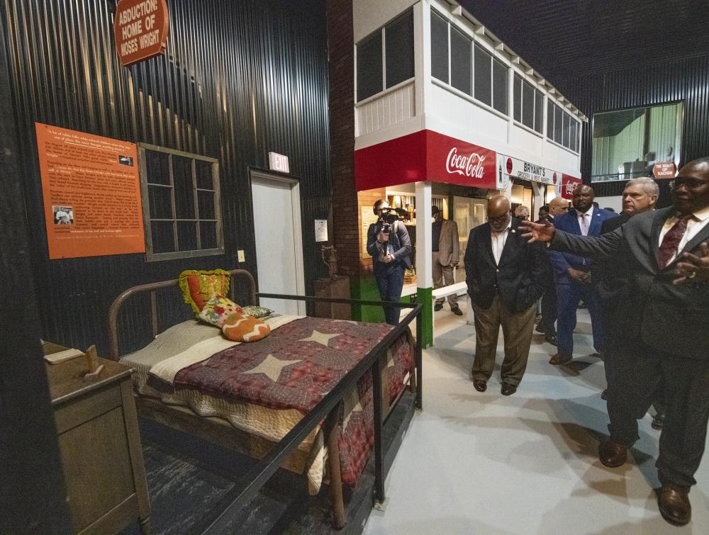 people led on a tour inside museum. they are looking at an old bed