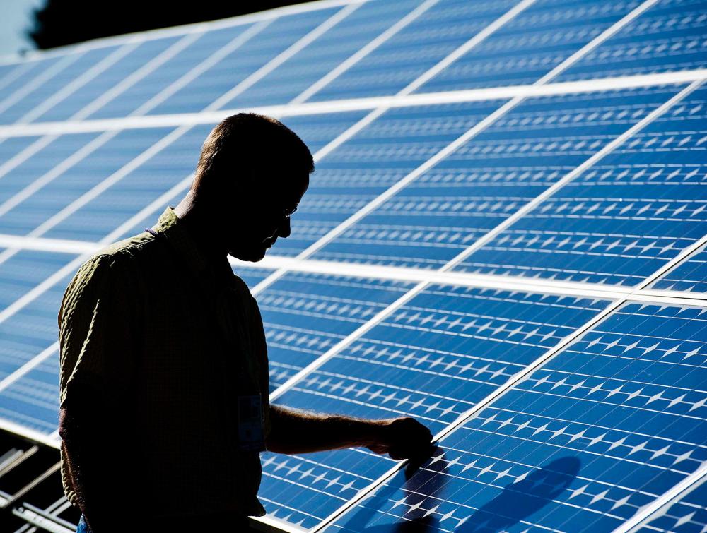 Person touching a solar panel 