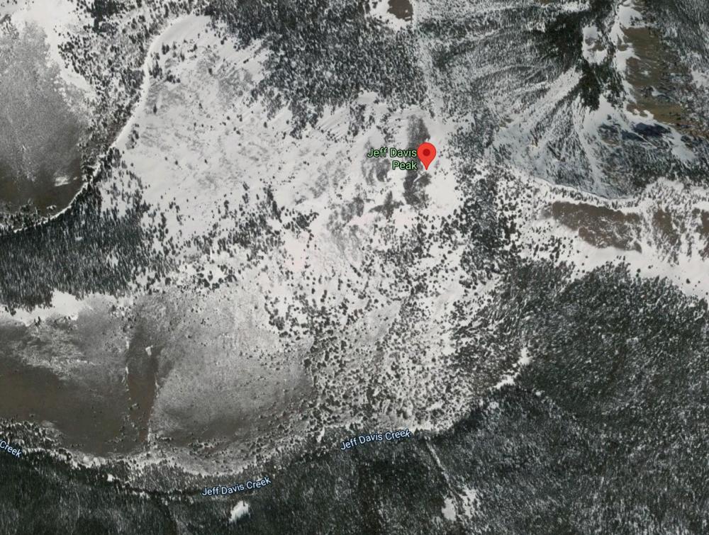 Screenshot of aerial satellite view of Google Maps image showing snowy mountain peak marked "Jeff Davis Peak"