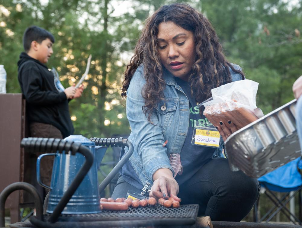 woman grilling in a campsite