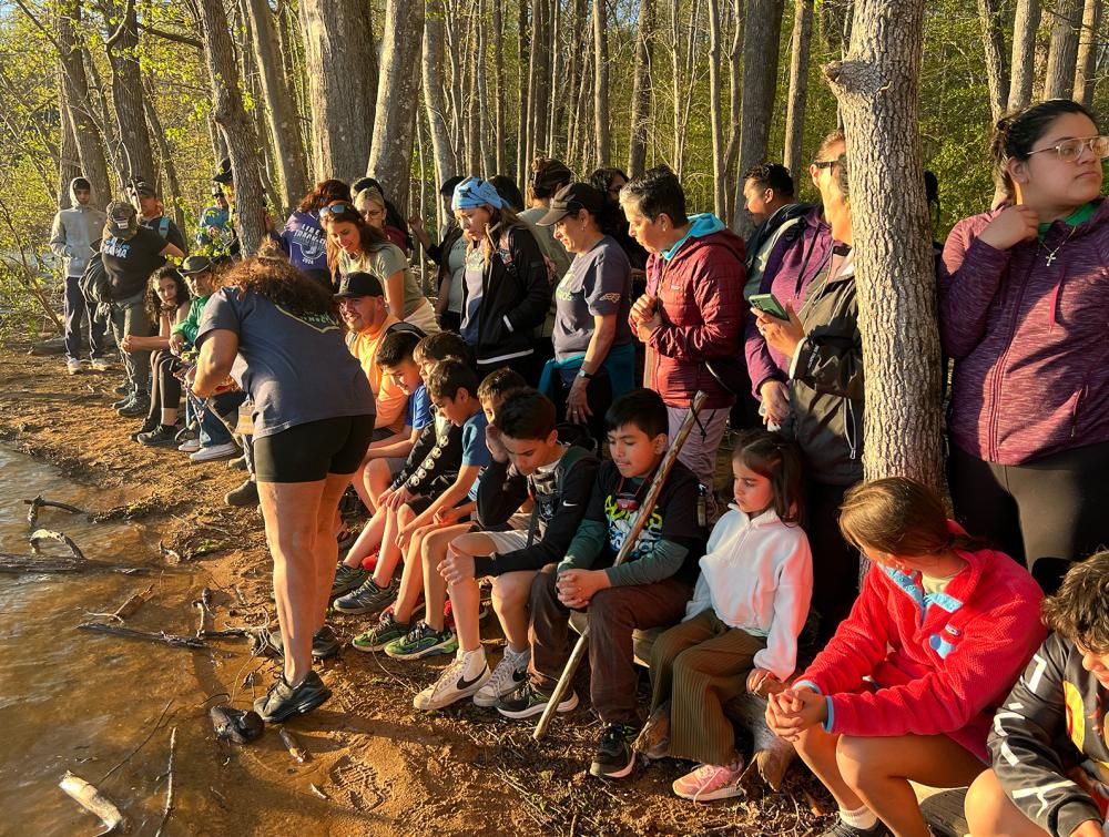 kids and families gathering in front of a lake