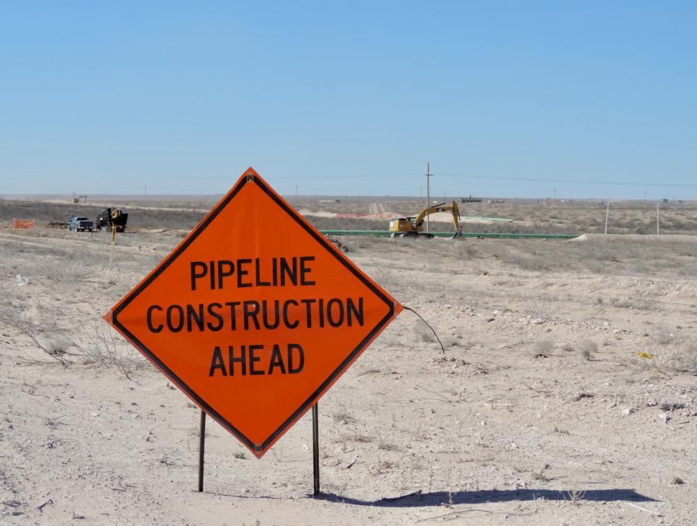 sign that says caution pipeline work ahead