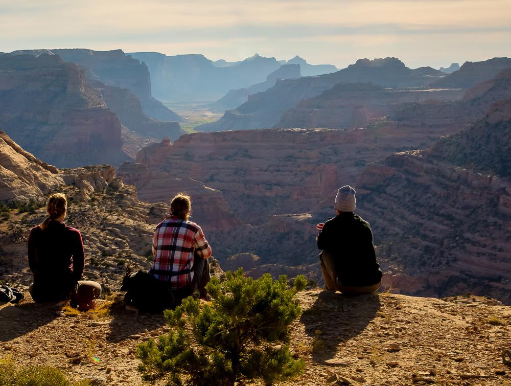 people sitting looking over mountains