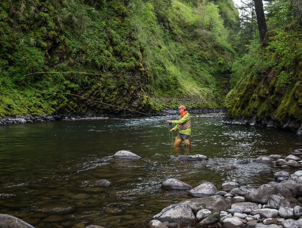 man fishing on river