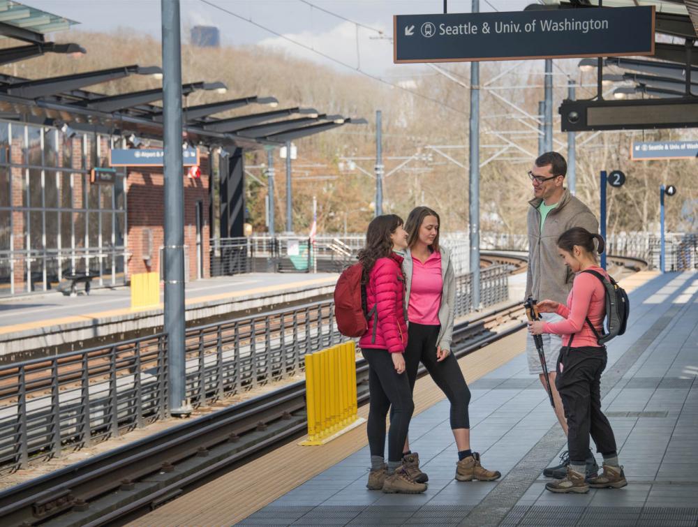Hikers in Seattle, Washington awaiting public transit to a trailhead.