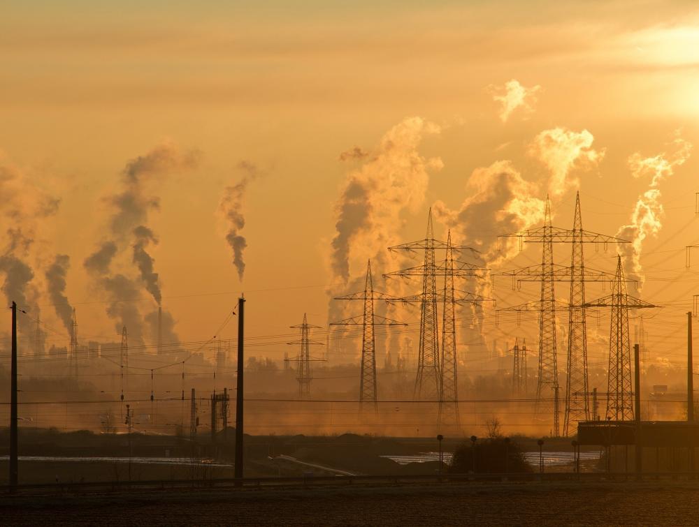 Pollution and power lines on an orange sky.