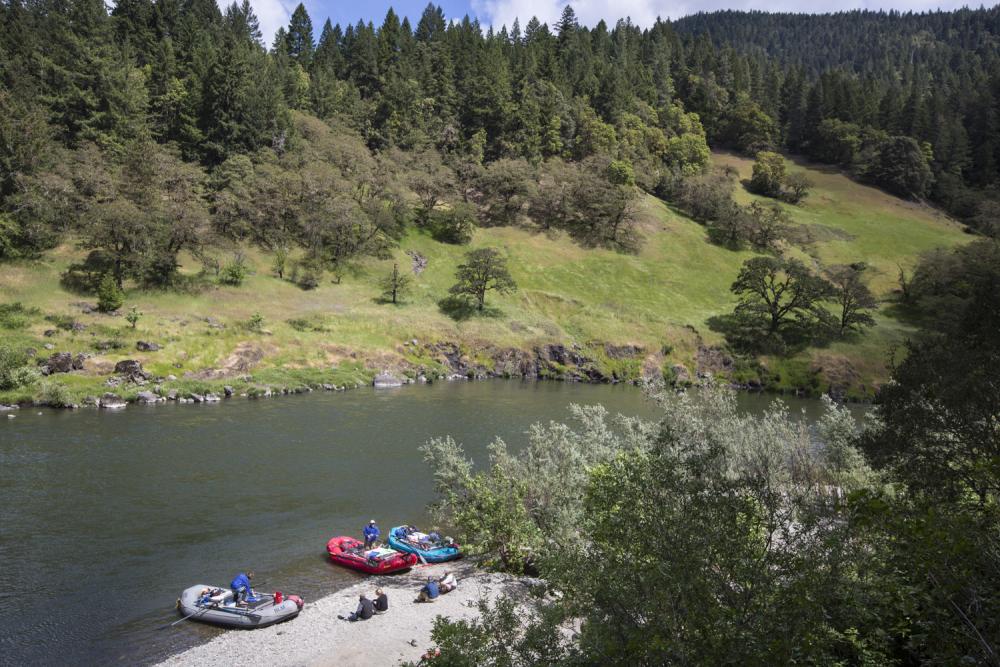 Rafters rest along the banks of the Rogue River in Oregon.