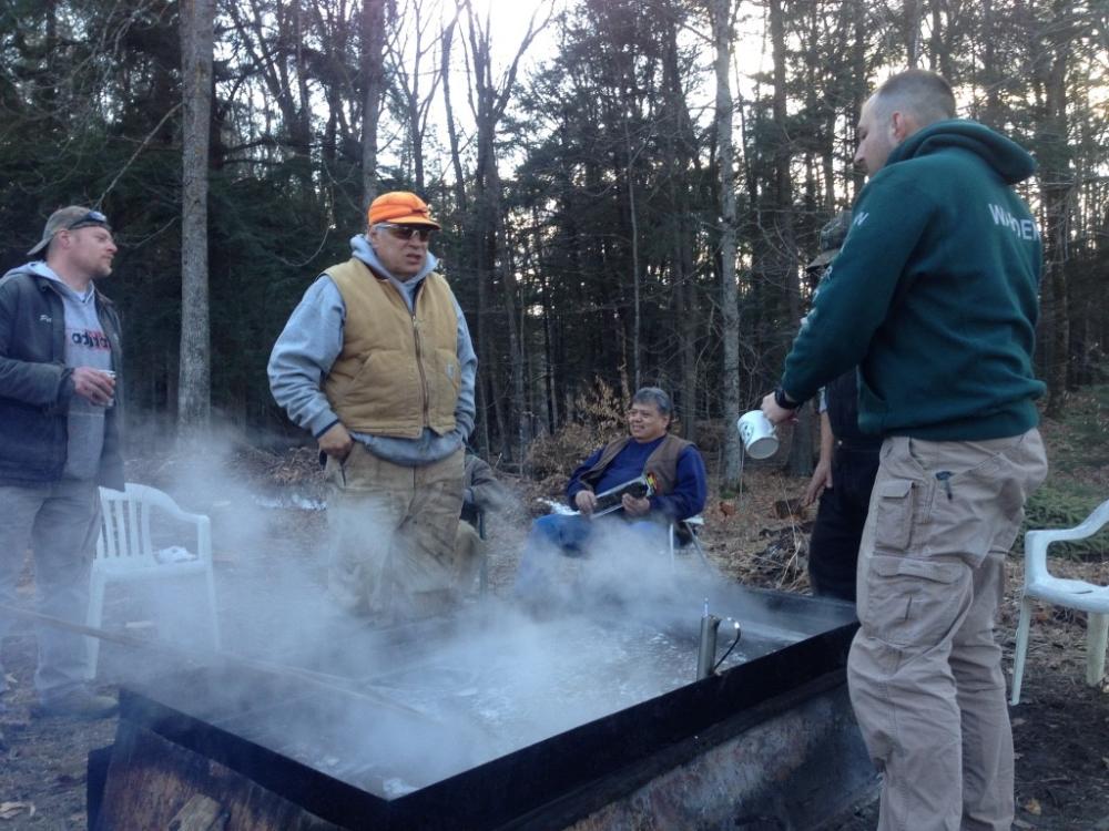Many stand in front of the sap boil monitoring it for sugar levels.