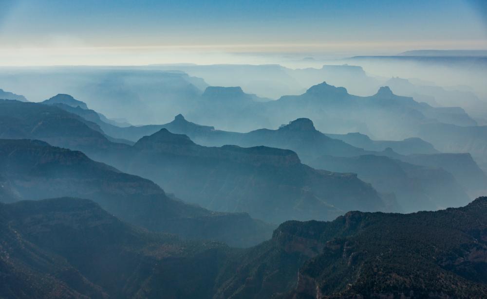 Rocky contours of Grand Canyon seen through shroud of fog from the North Rim