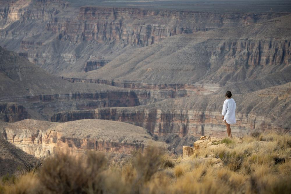 The author stands over a canyon at BaajNwaavjol'tahKukveni National Monument, New Mexico