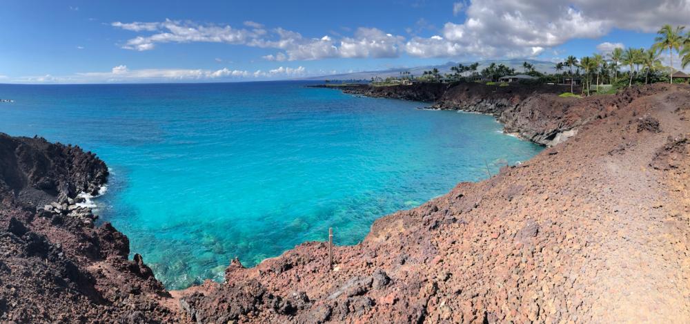 Clear ocean water against a cliff.