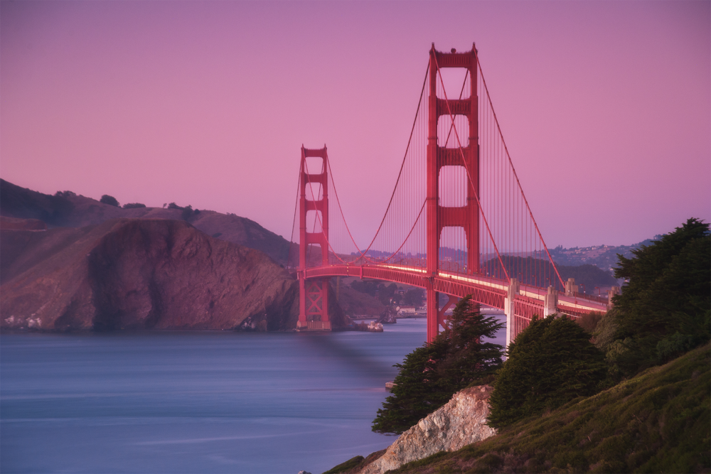 pink sky over the Golden Gate bridge across water