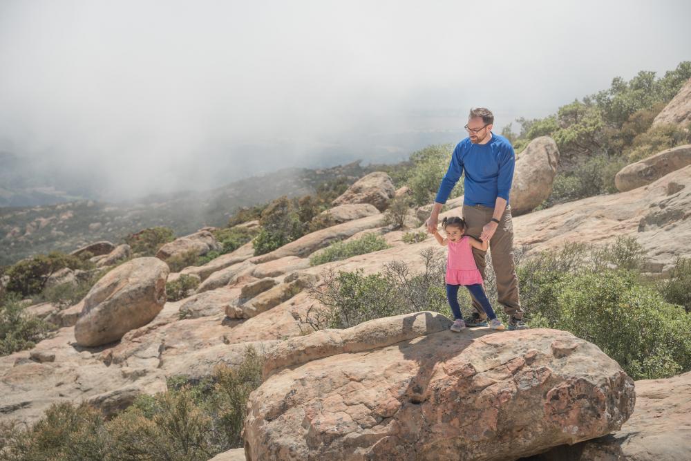 Man and girl hiking on rocks in Los Padres National Forest, California