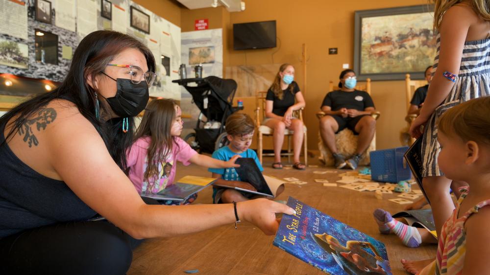 women surrounded by kids 