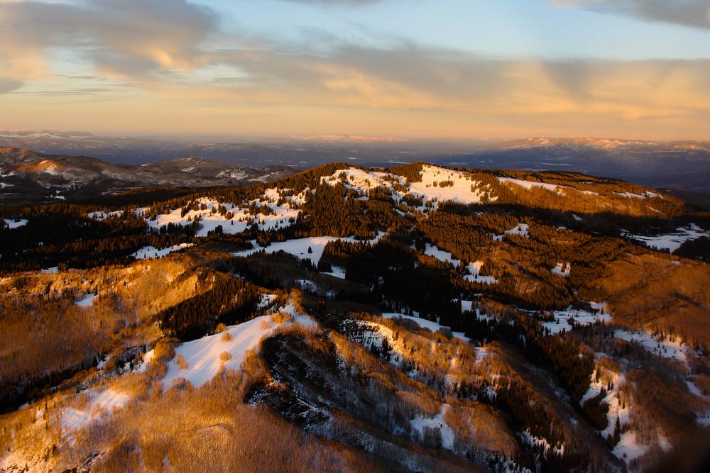 aerial photo of mountains with some snow left