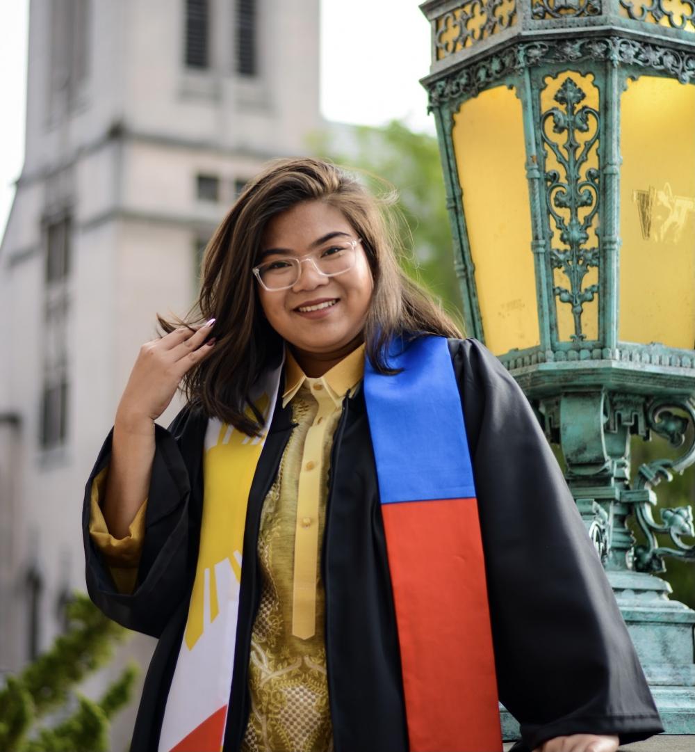 Eya, in graduation gown outside