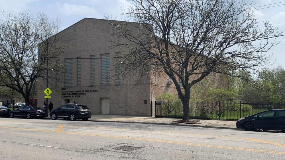 exterior of brick church structure with trees without leaves in front