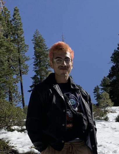 Jacob, standing in front of trees in the snow