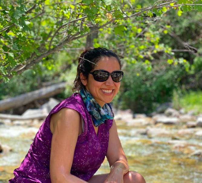 Person sitting by river