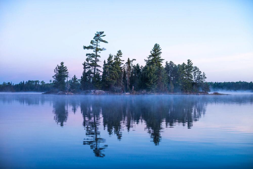 Trees and water at sunset in Boundary Waters Canoe Area, Minnesota.