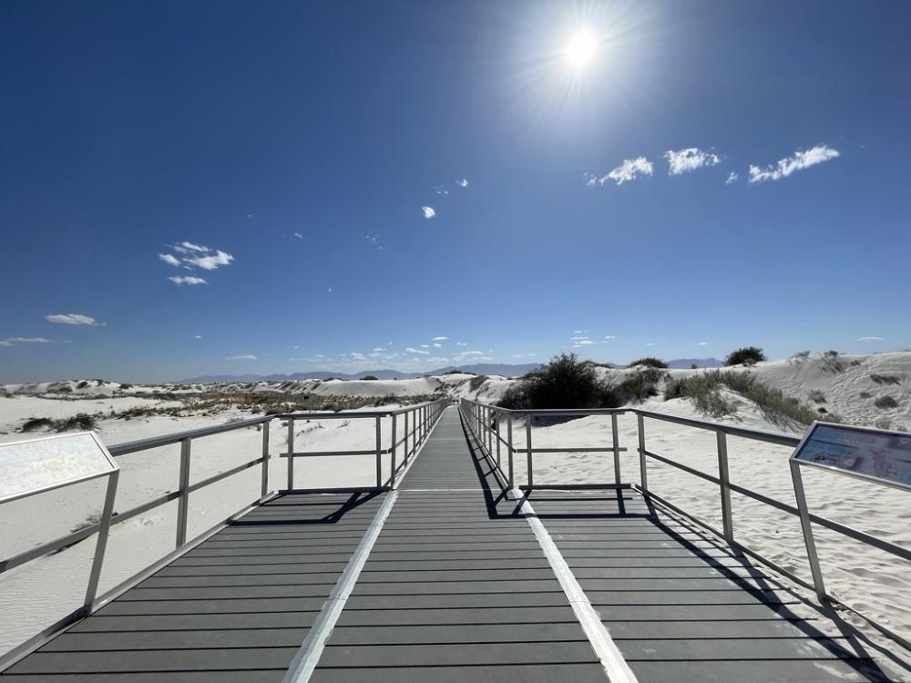 bridge with handrails on top of white sands 