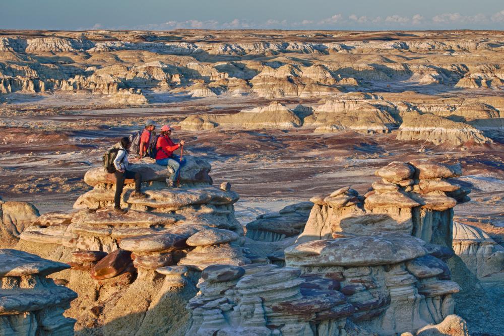 A group of hikers on a sandstone formation in Ah-shi-sle-pah Wilderness Study Area, New Mexico