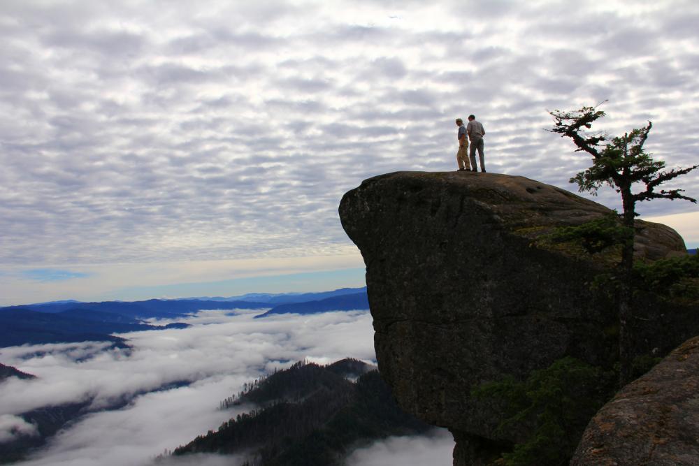 Hikers on a rocky ledge in Wild Rogue Wilderness, Oregon