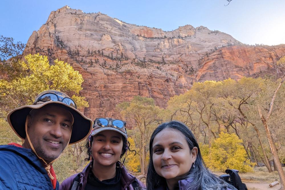 family standing with canyon's in the background