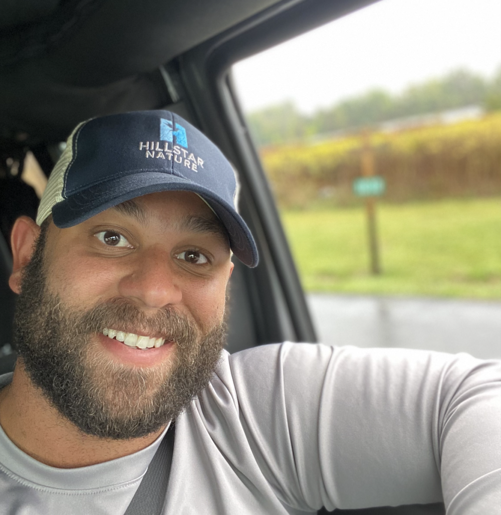 Selfie of man smiling inside a car