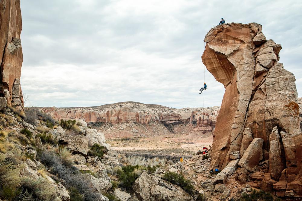 Person rappelling off of rock formation in Bears Ears National Monument, Utah