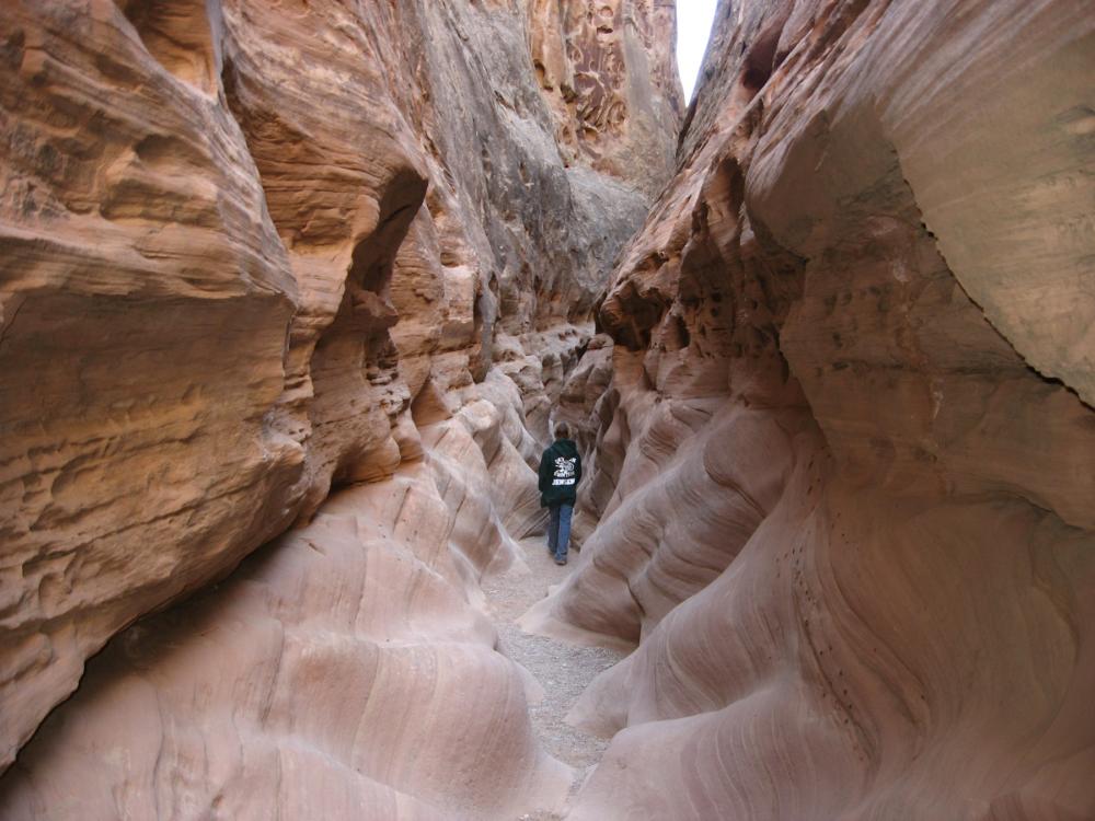 Hiker in Little Wildhorse Canyon within the Crack Canyon Wilderness Study Area, Utah