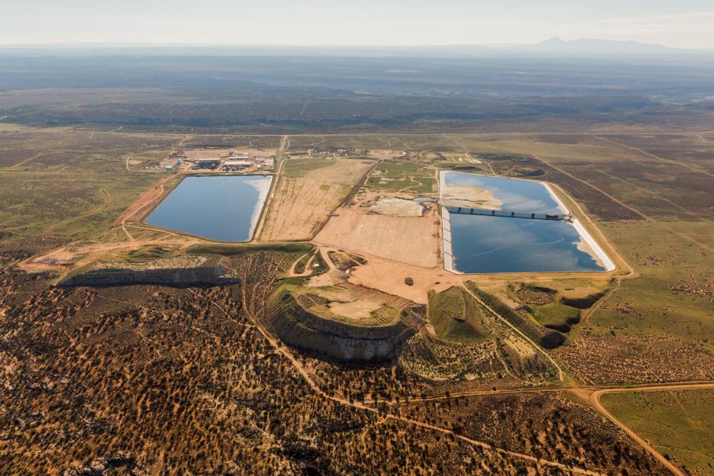 Aerial three-quarters view of industrial site with two large impoundments, or pools of water, visible