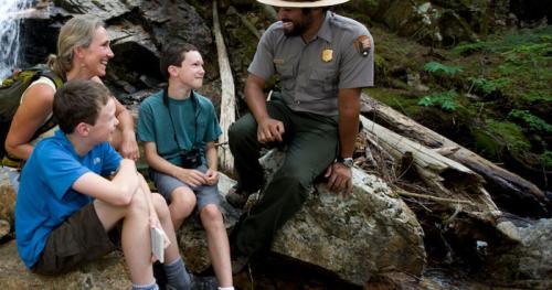 Family visiting with a park ranger