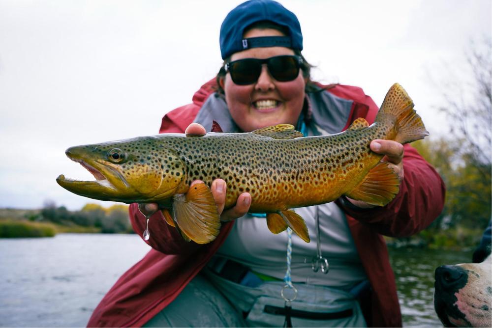 person holding a fish and showing it to the camera